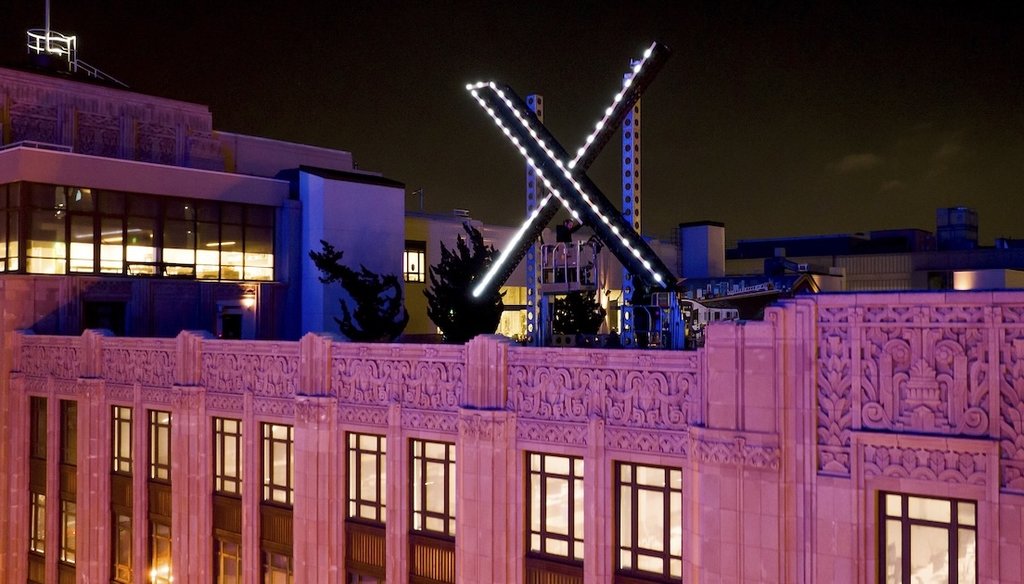 Workers install lighting on an "X" sign atop the company headquarters in downtown San Francisco, July 28, 2023. (AP)